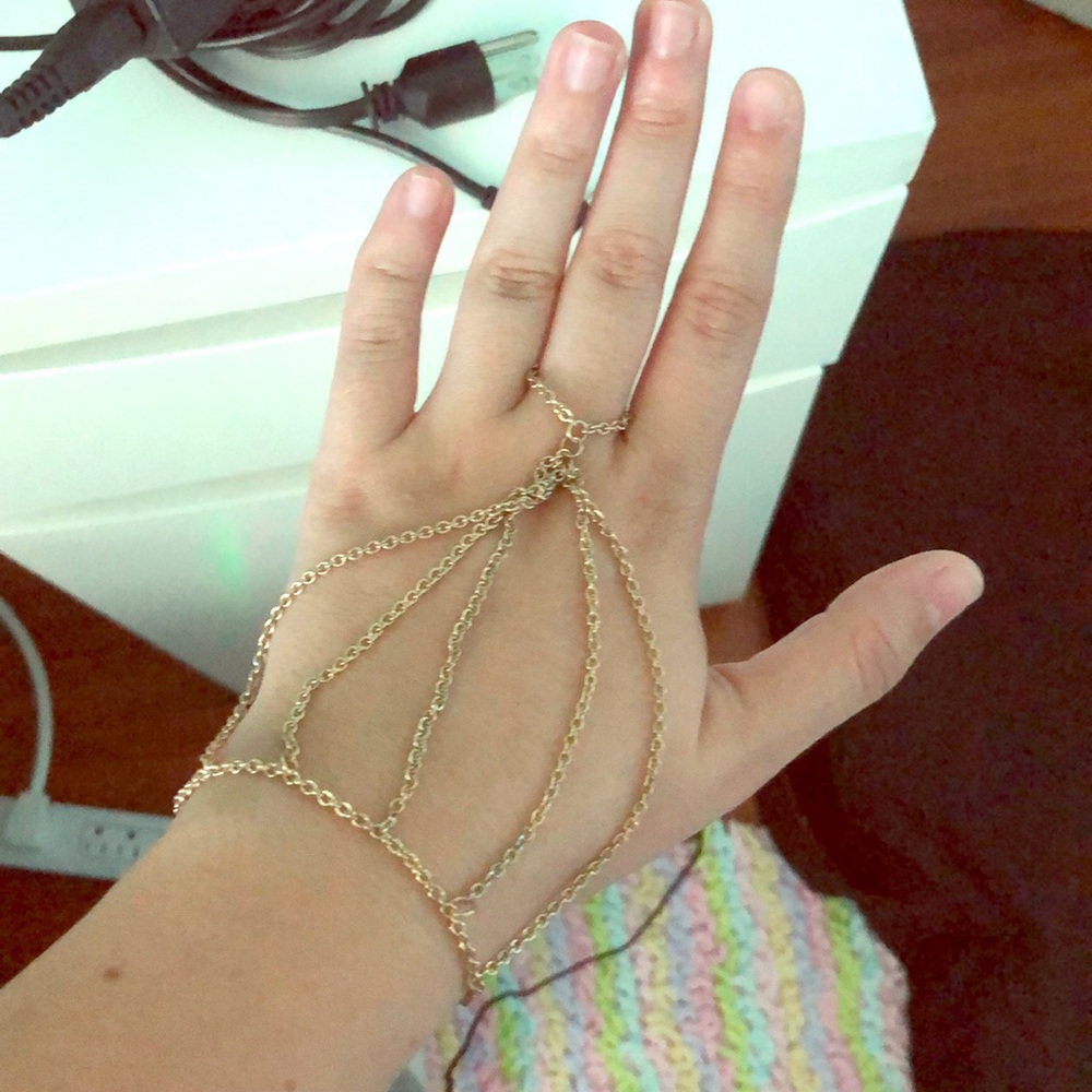Gold bracelet with ring connected